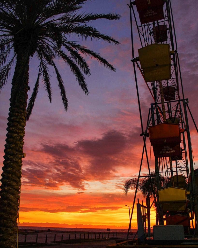 Sunset in the background of a ferris wheel at Corpus Christi