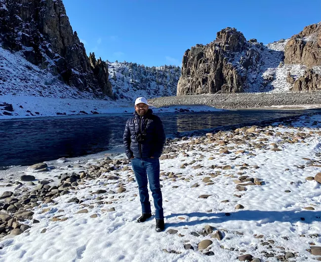 Curecanti winter gear in front of river with blue skies