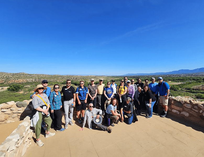 WNPA board of directors in front of blue skies and a brick wall at Tuzigoot National Monument