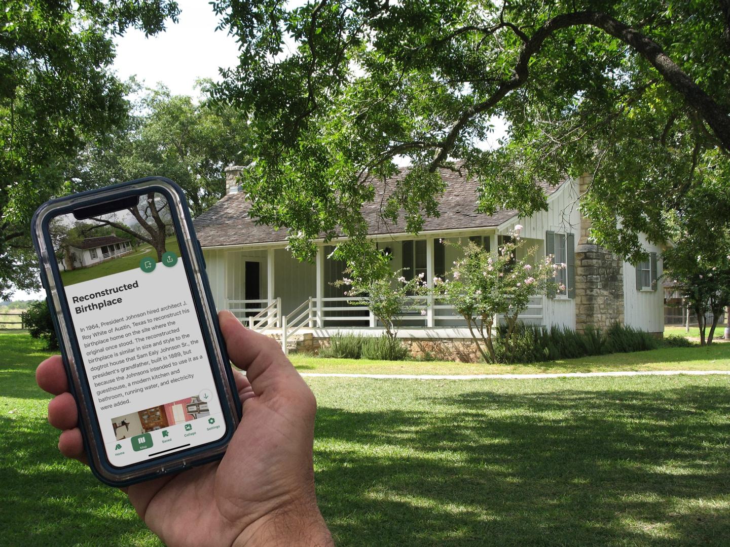 Hand holding a phone, displaying text, with a white house in the background.