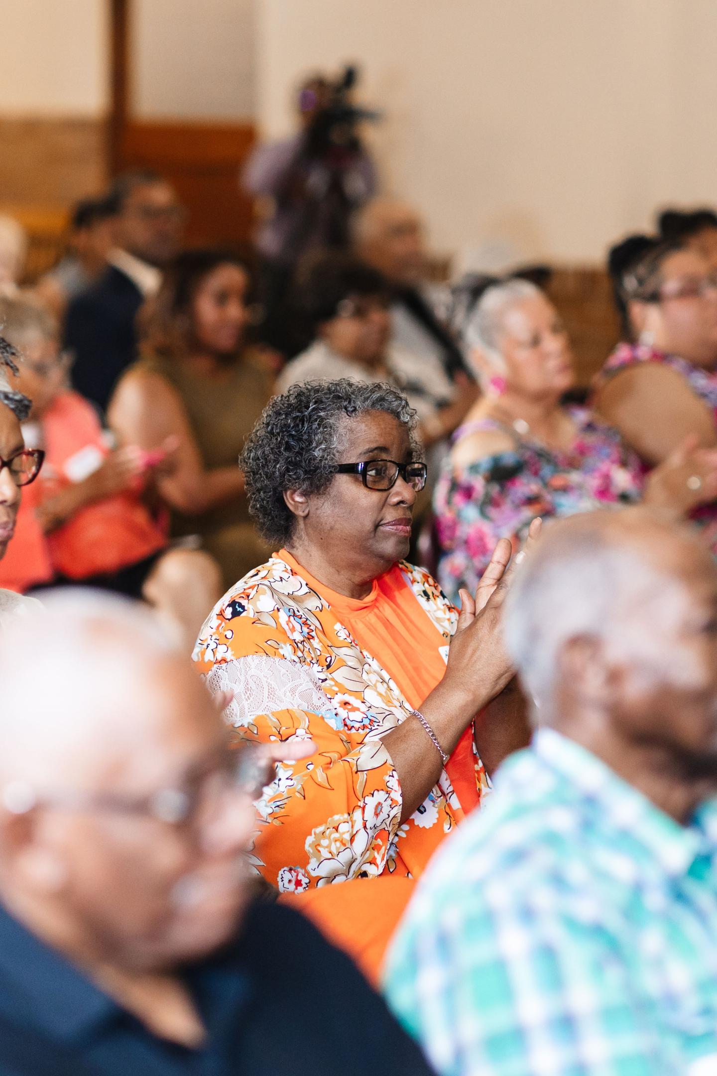 Audience attentively listening at a community event.