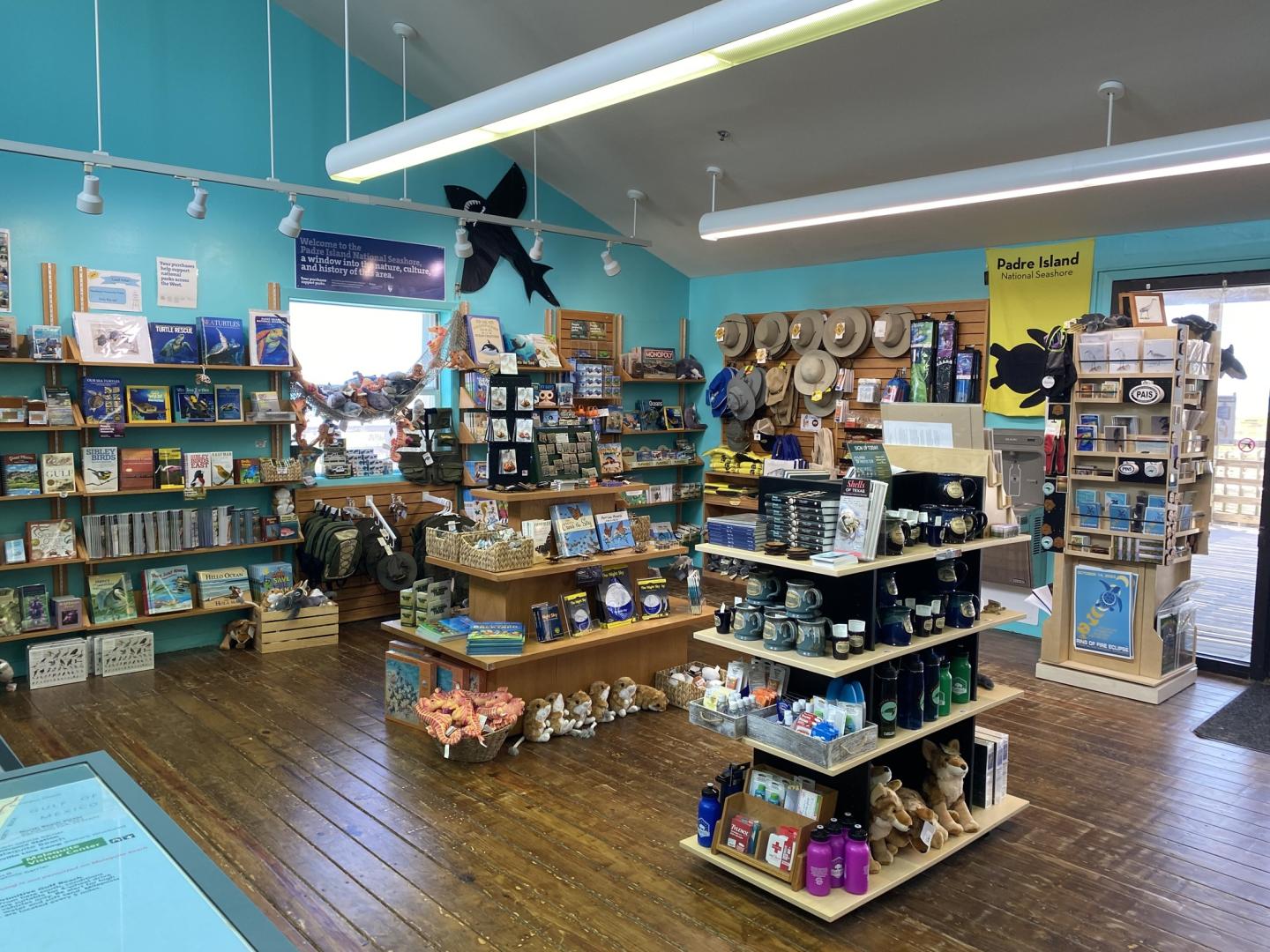 Malaquite Visitor Center with souvenirs, books, and hats on wooden shelves and displays.