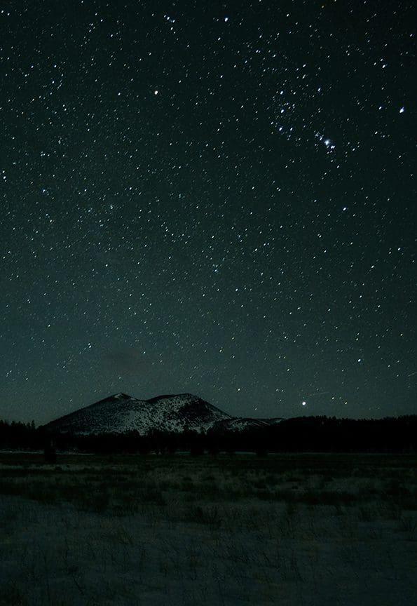 The constellation Orion rises over Sunset Crater Volcano.