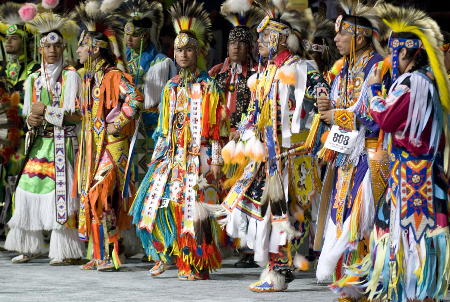 Dancers in vibrant traditional regalia at a cultural event.