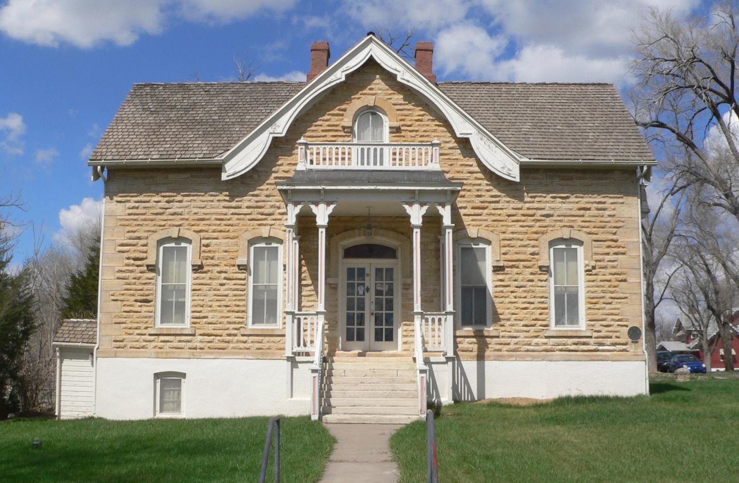 Mueller-Schmidt House with front porch and tall windows.