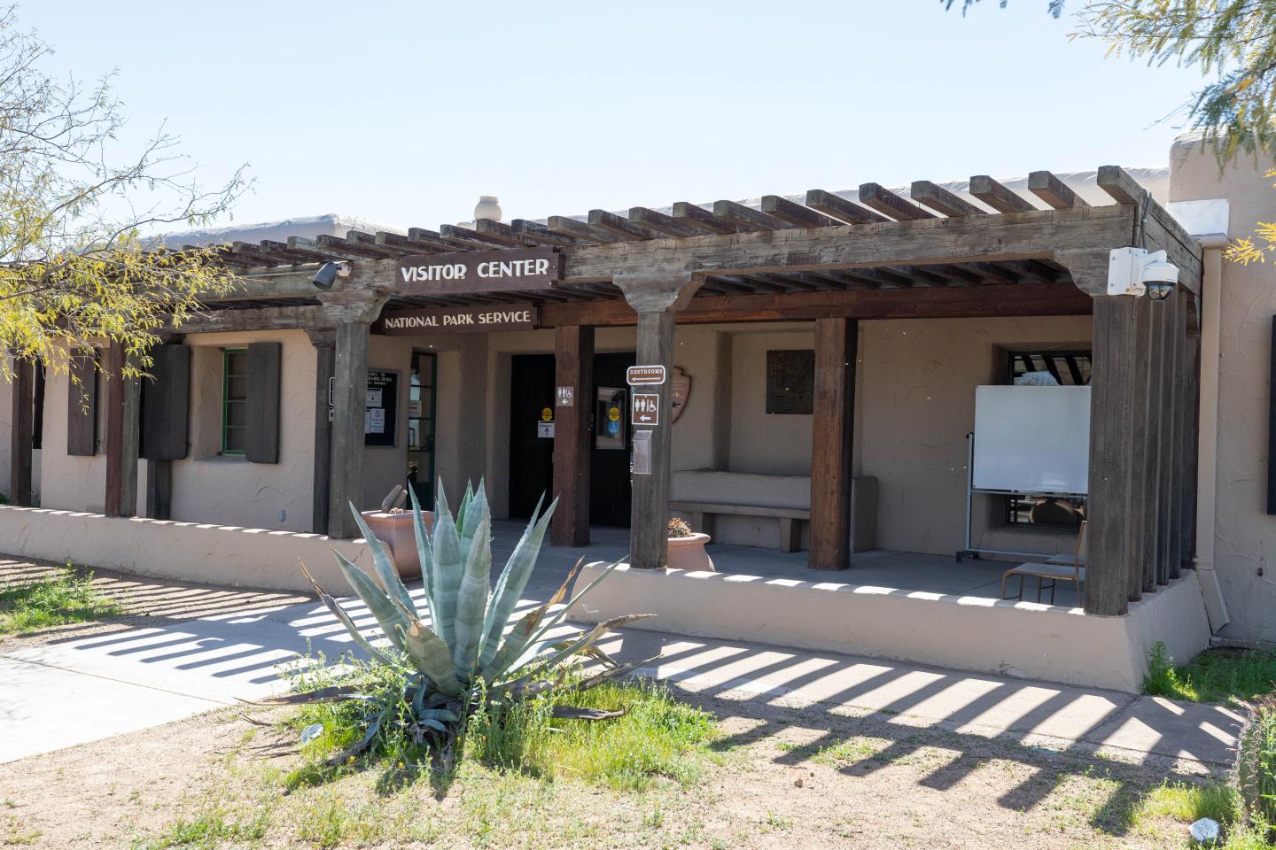 Desert Visitor Center with wooden pergola and agave plant.
