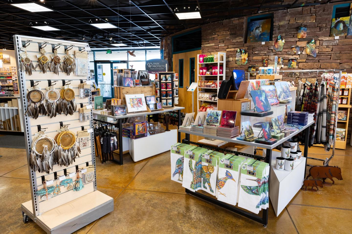 The National Parks Store with displays of artworks, dreamcatchers, park collectibles, and colorful merchandise.