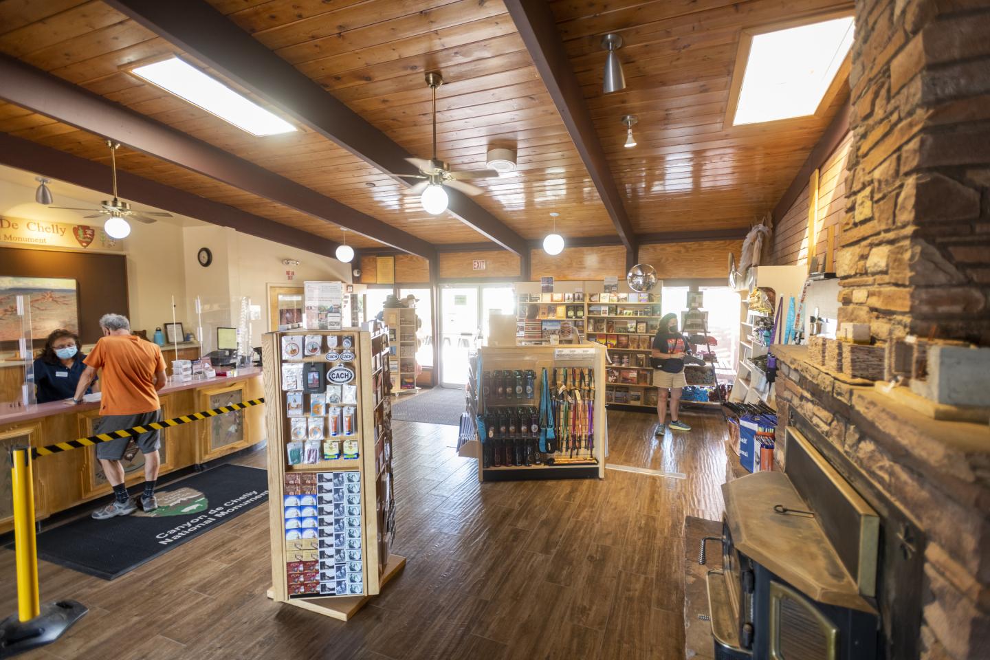 Cozy Canyon De Chelly park store interior with wooden ceiling and displays of goods.