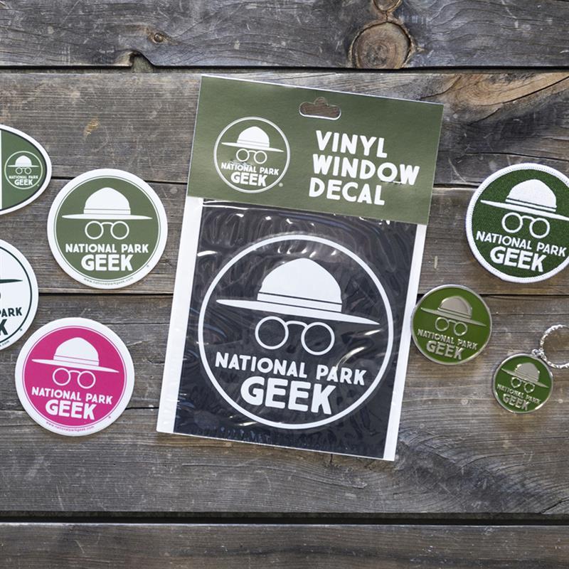 Vinyl decals with "National Park Geek" logo on a wooden surface.
