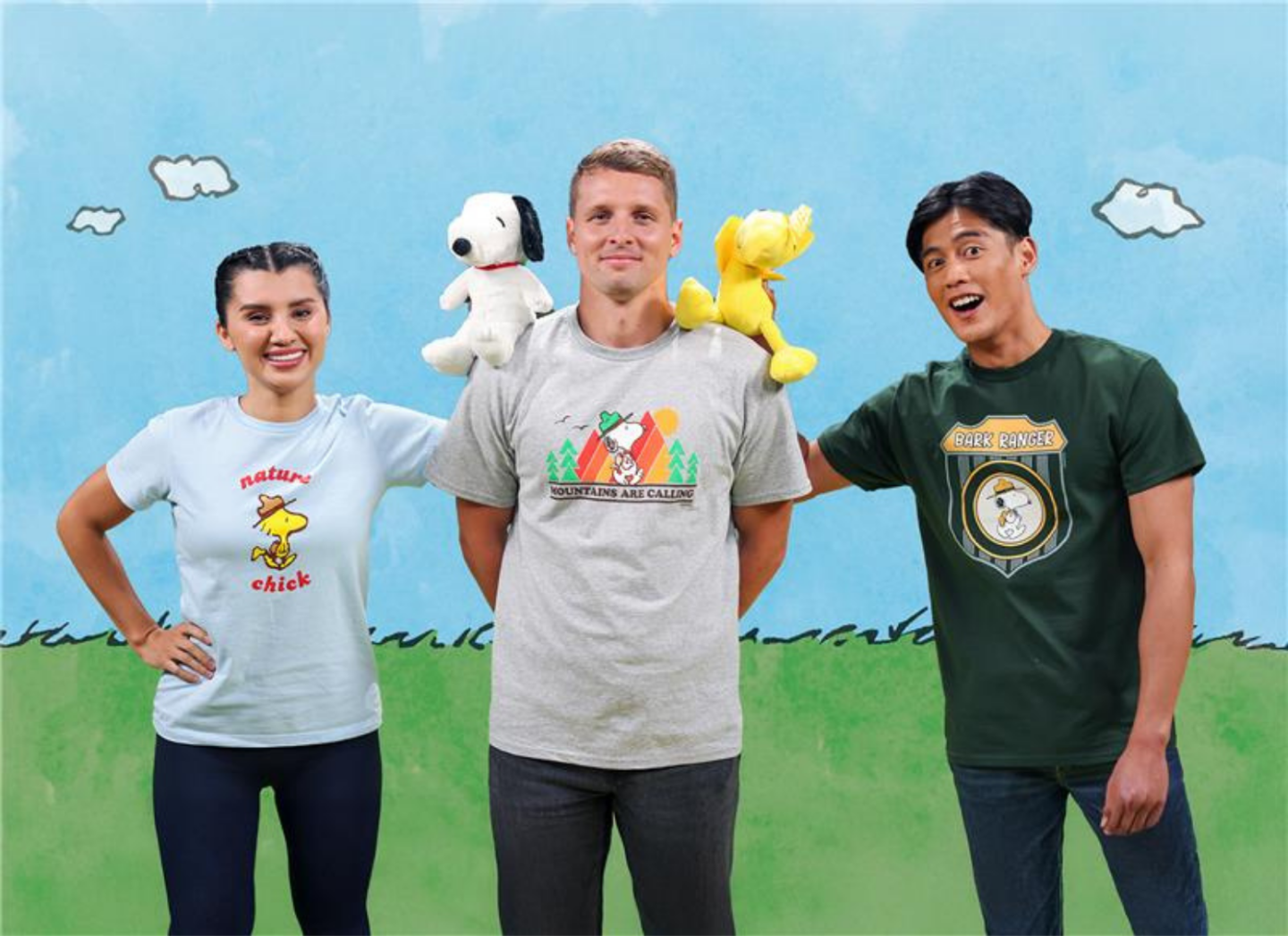 Three people wearing themed shirts with cartoon plush toys on their shoulders, standing outdoors.