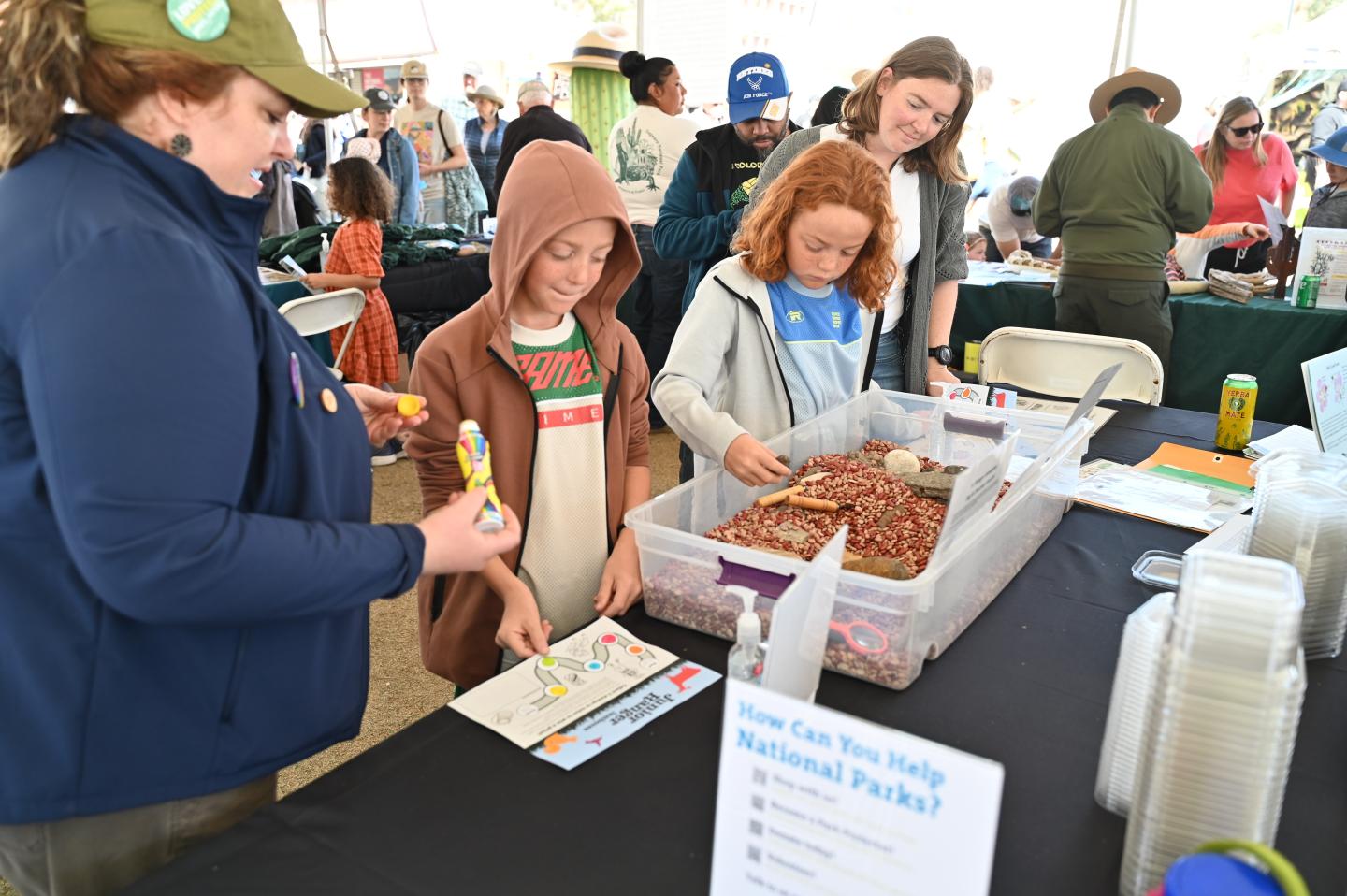 People participating in an educational activity at a booth.