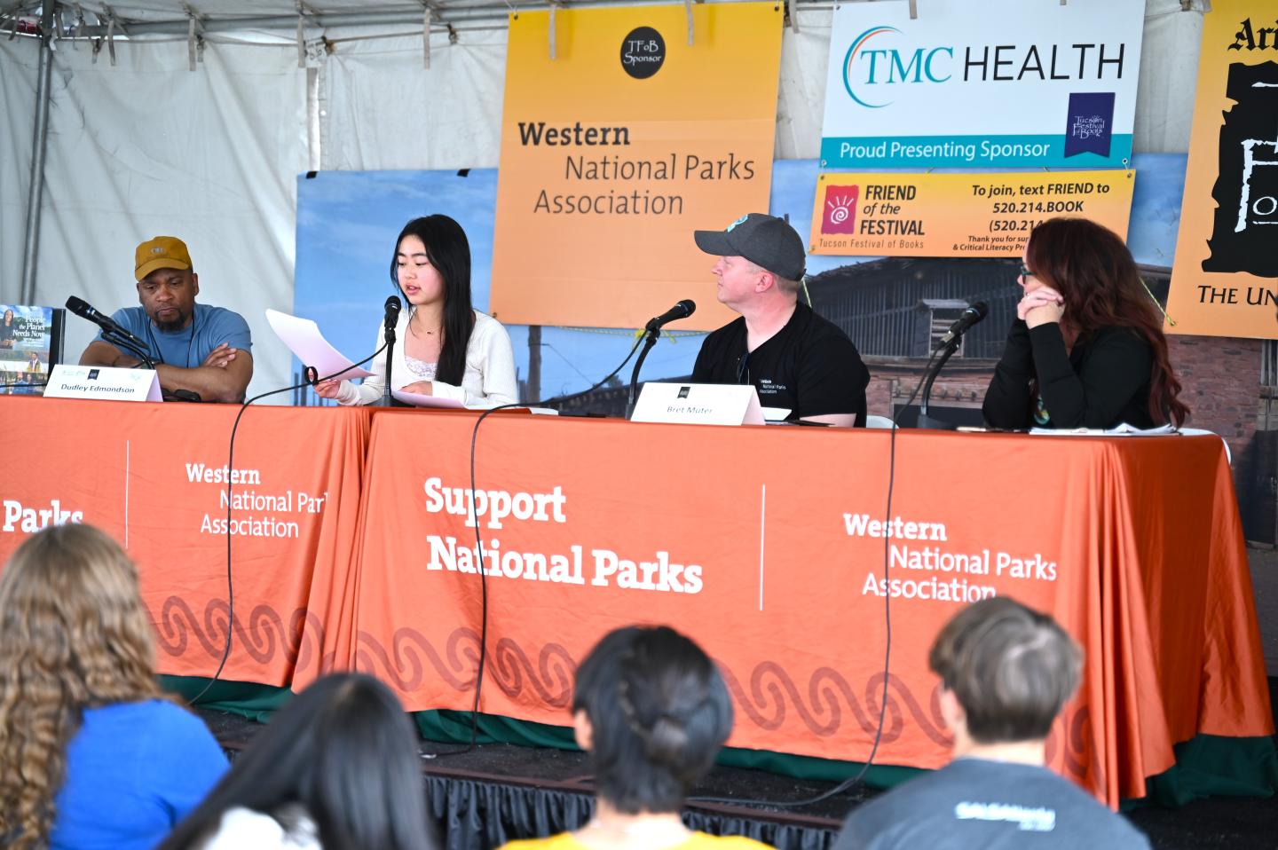 Panel discussion at a National Parks event with four people at a table.