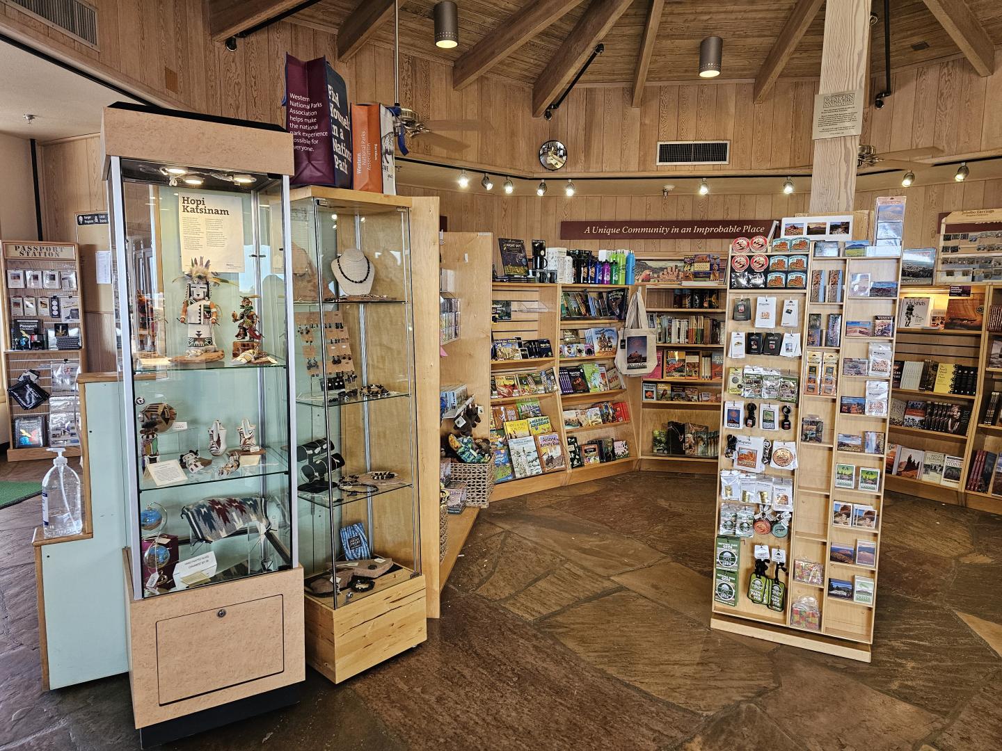Wupatki park store with wooden shelves, postcards, and glass display case.