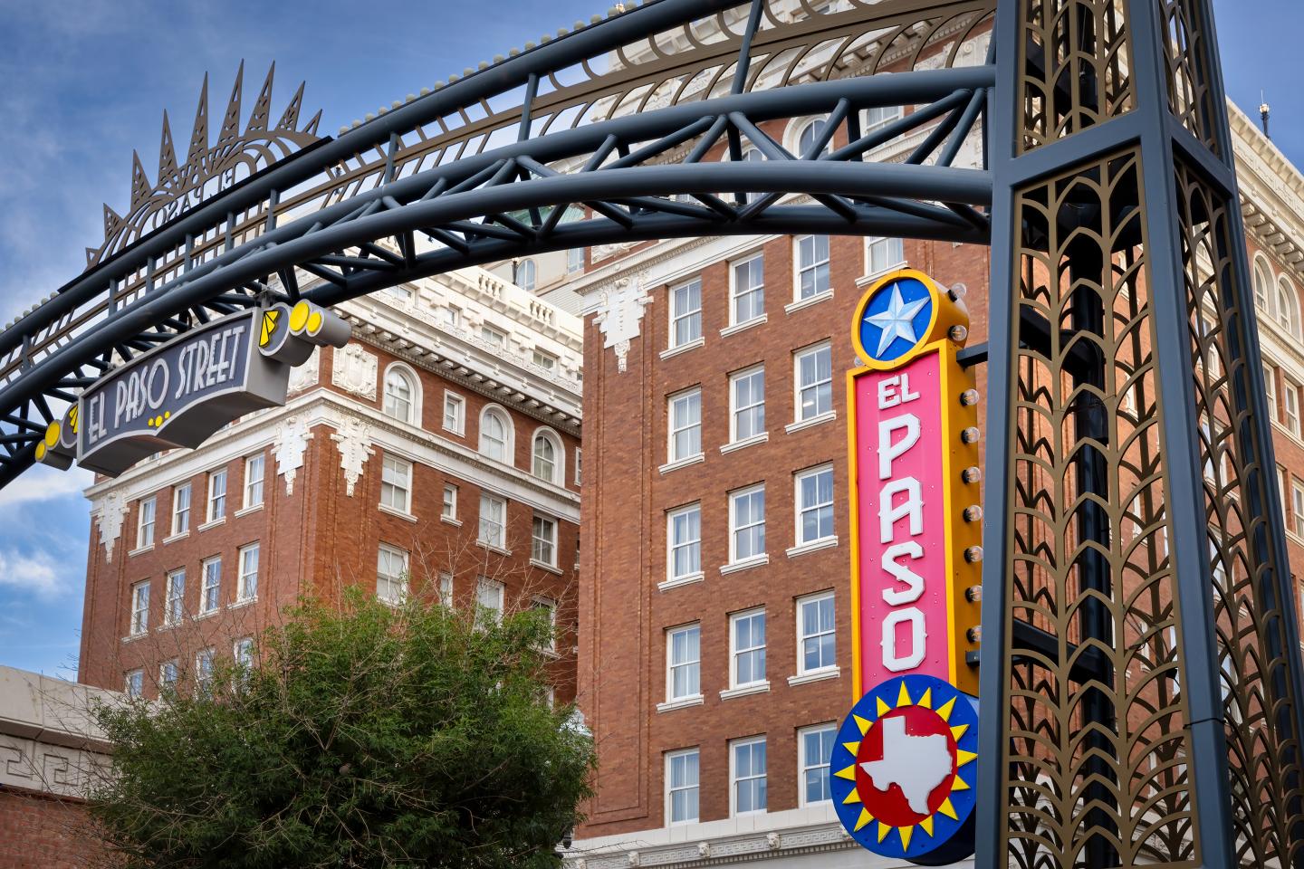 Historic brick building with El Paso sign under blue sky.