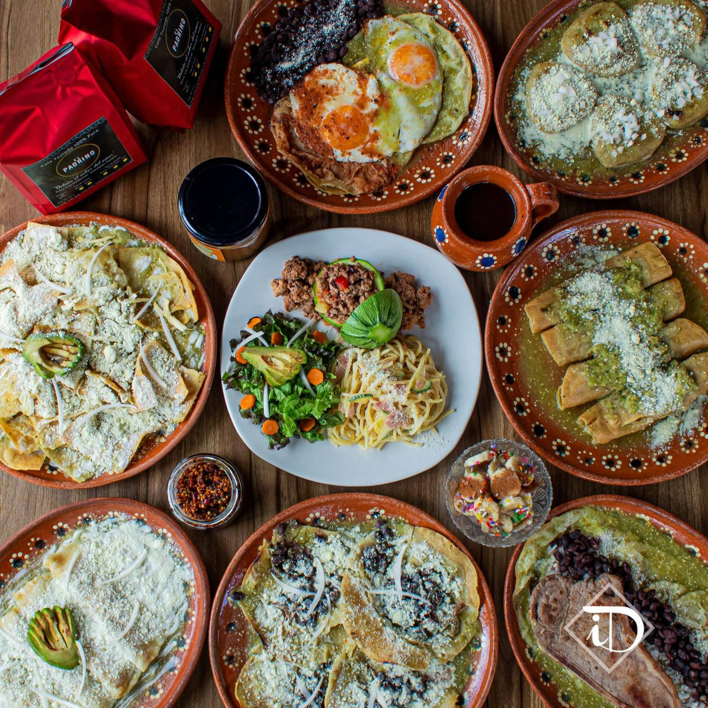A variety of Mexican dishes on colorful ceramic plates.