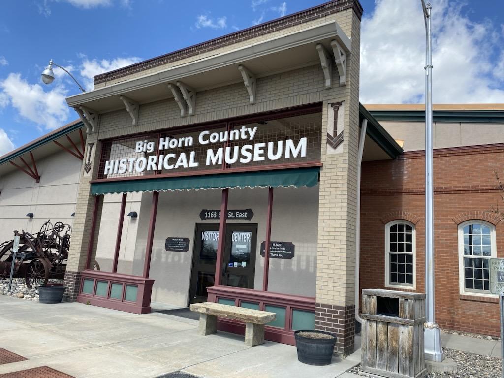 Horn County Historical Museum entrance with red accents under a blue sky.