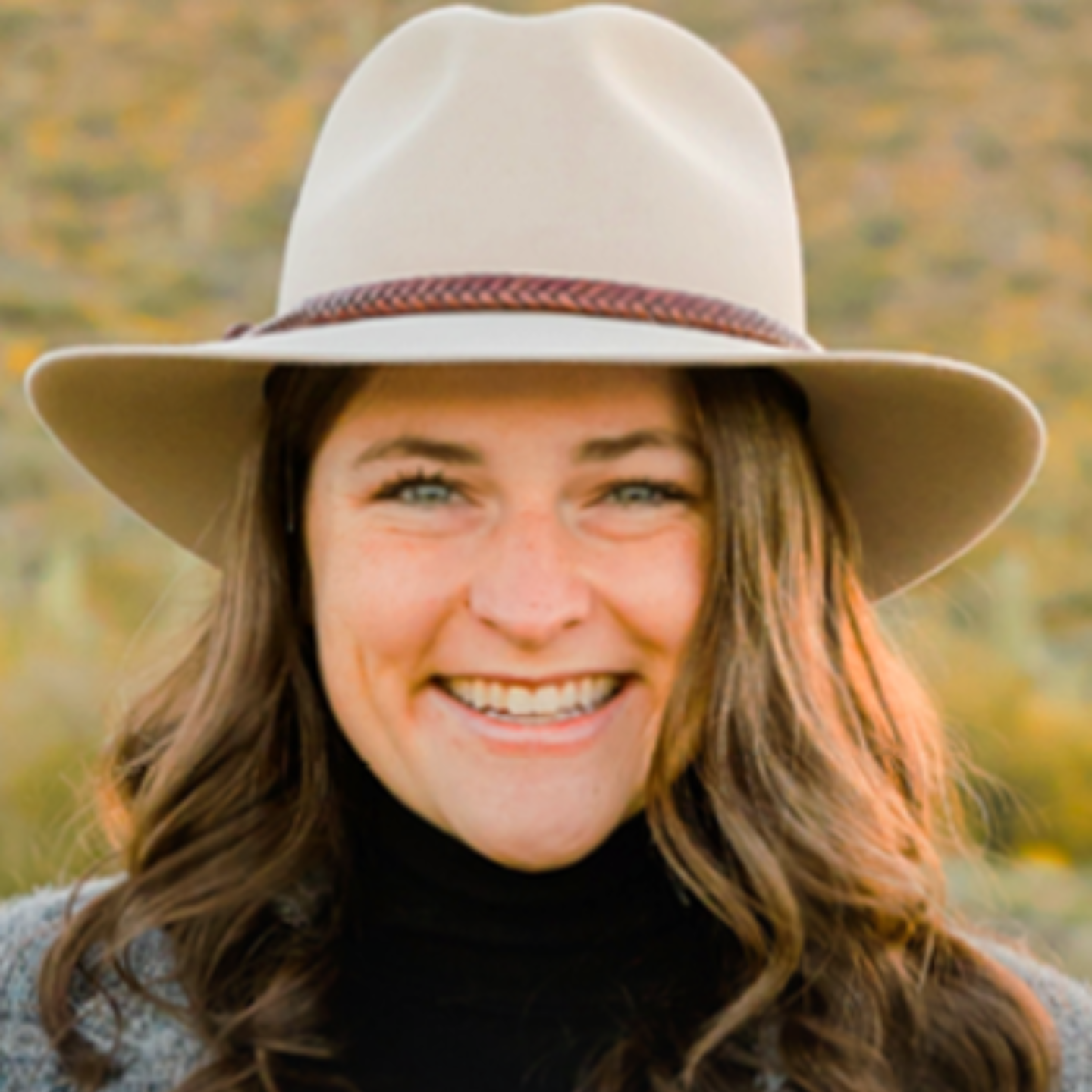 Maddie Pellman, 2024 Recipient of Stewart L. Udall Award, in a wide-brimmed hat outdoors.