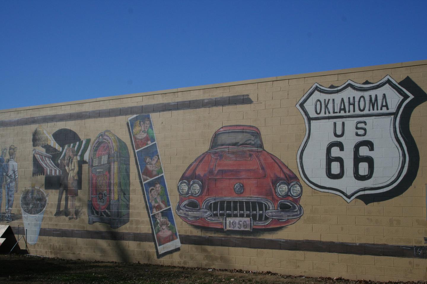 Mural depicting Route 66 with a red car and Oklahoma sign.