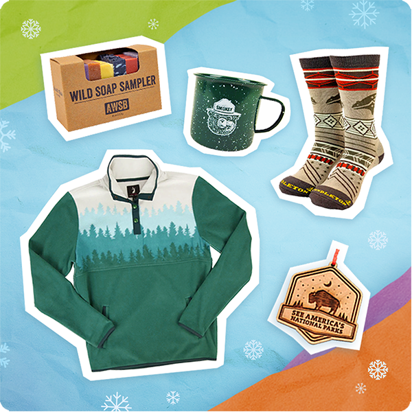 Green pullover, patterned socks, mug, soap box, and bear-themed ornament on colored background.
