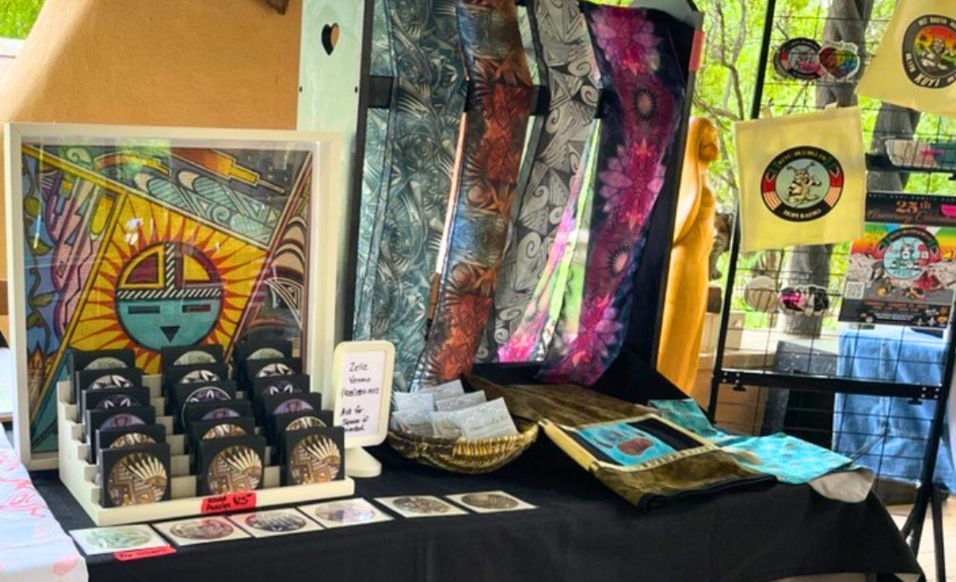 Market stall with colorful textiles, notecards, and art by Hopi artist Monica Nuvamsadisplayed