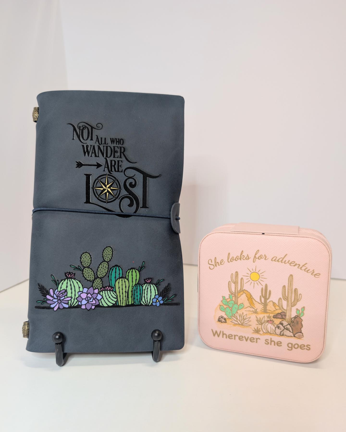 Dark leather journal with cactus design and small pink pouch with desert scene.