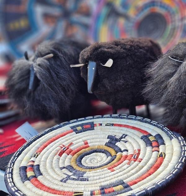 Woven basket with sheep figurines in the background.