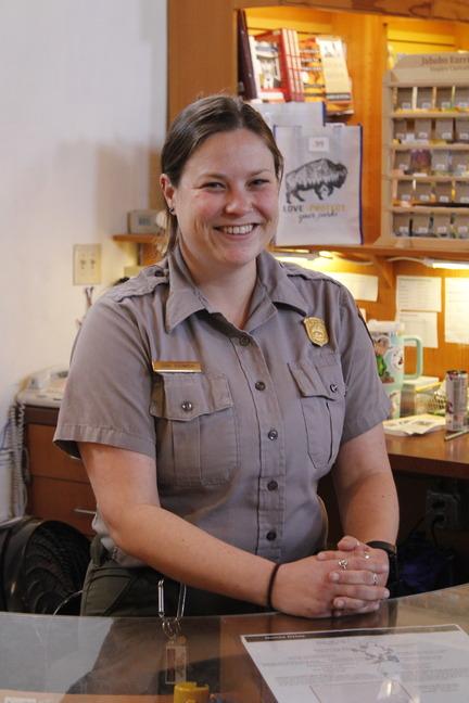 Park ranger smiling at the information desk.