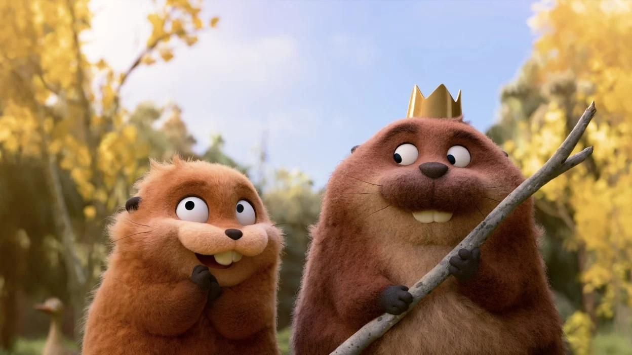 Two animated beavers, one with a crown, from the Pixar movie "Hoppers", in a sunny forest.