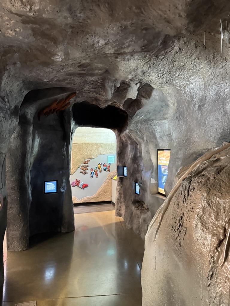 Cave-like museum exhibit with screens and a mural at Timpanogos Cave National Monument.