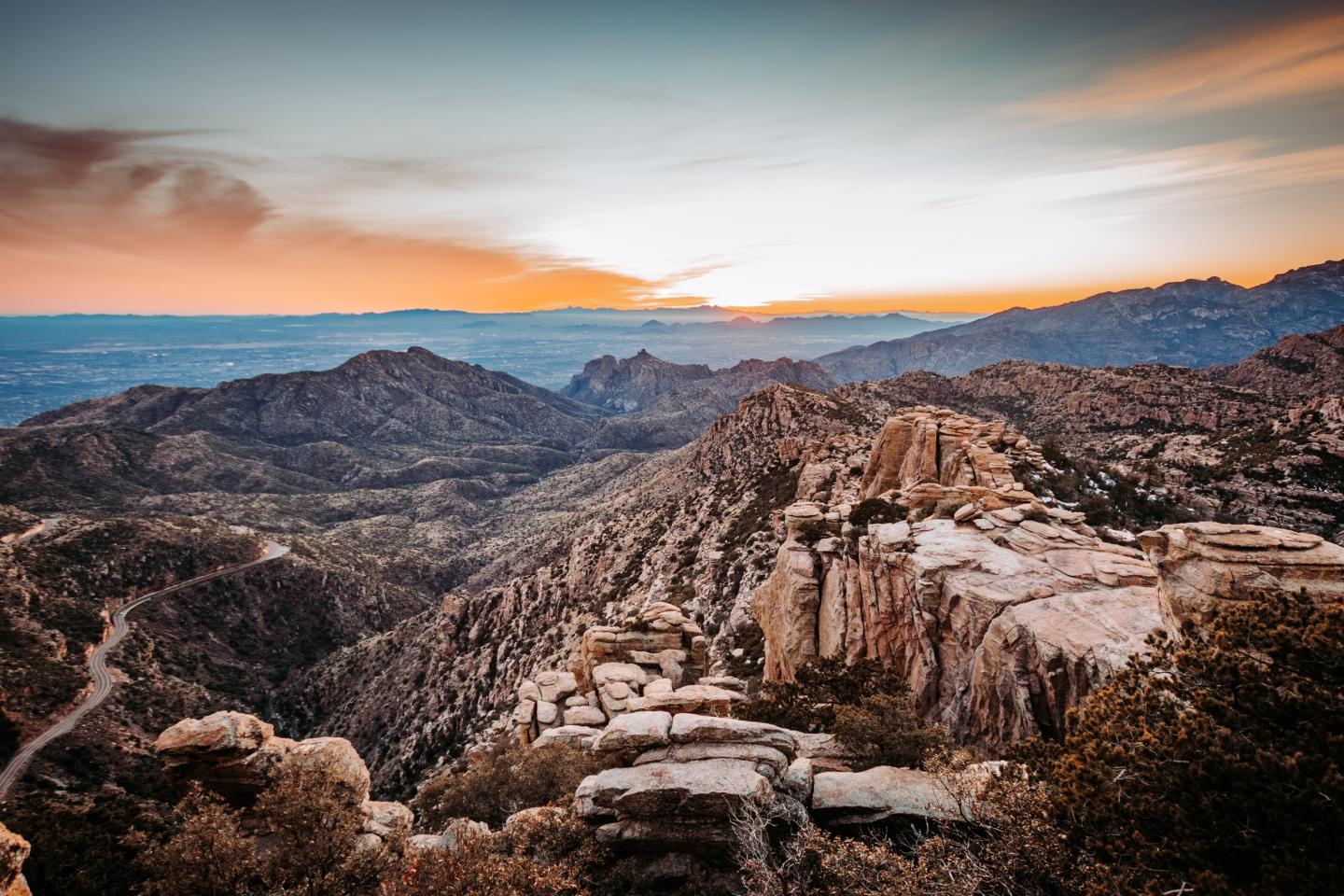 Rocky landscape with distant mountains at sunset on Mt. Lemmon..