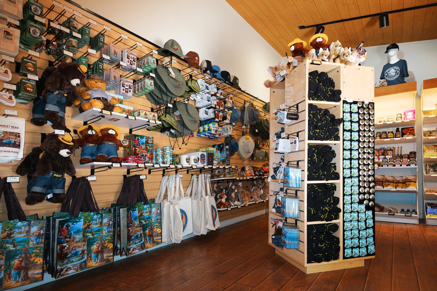 A store display with stuffed animals, hats, and souvenirs.