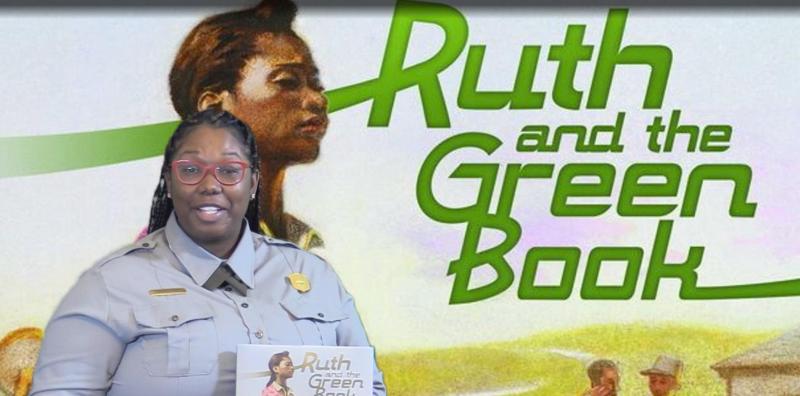 A Black park ranger standing in front of an image with "Ruth and the Green Book" displayed behind.