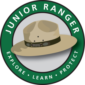 round logo says Junior Ranger - Explore, Learn, Protect with a ranger hat in the center