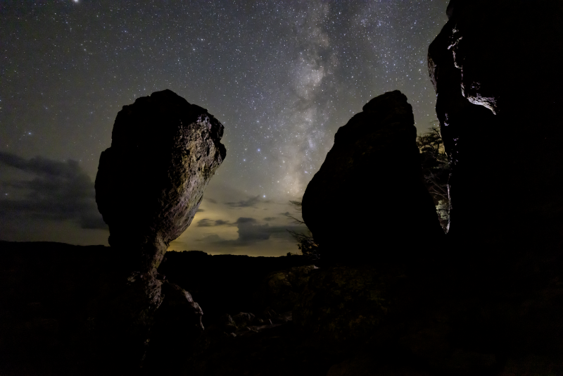 silhouette of a rock in front ot stars and the Milky Way