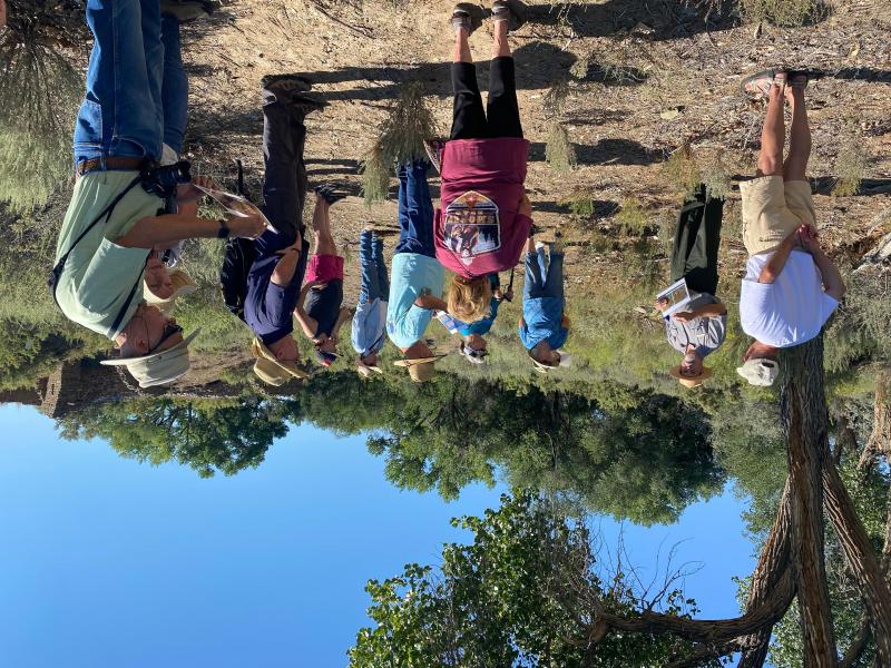 A ranger talking to a group of visitors in front of the remnants of a sandstone structure.