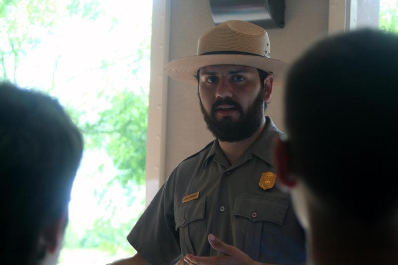 Park Ranger talking to two visitors.