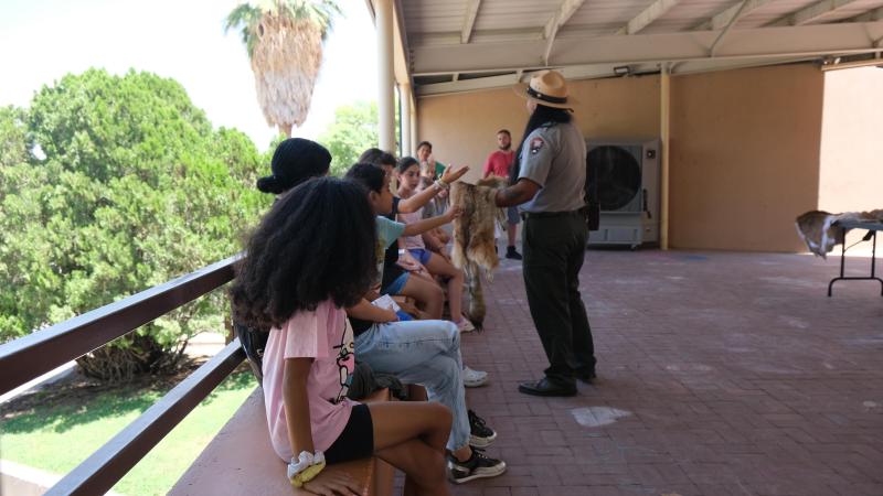 A ranger presenting to a group of children.