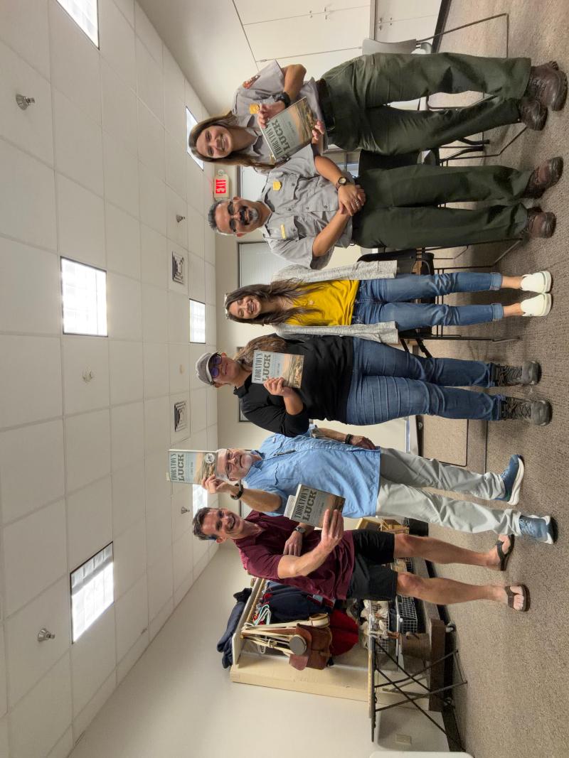 Park rangers and friends with books