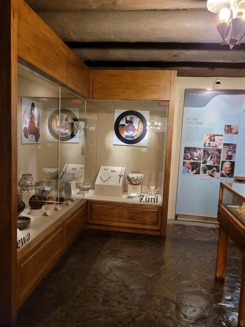 Pottery, jewelry and paintings made by artists from Zuni and Tewa communities displayed in a museum