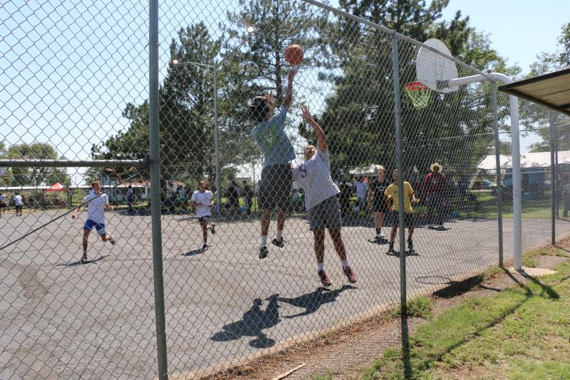A group of kids on a basketball court playing basketball