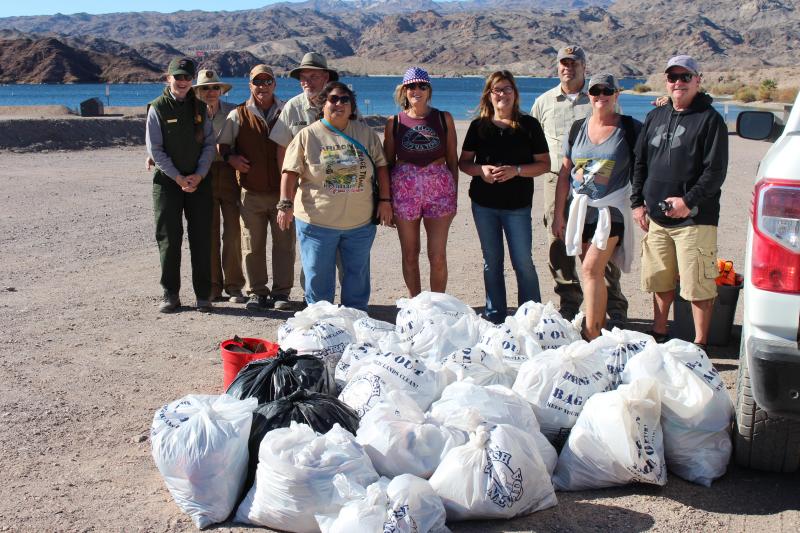 Volunteers standing with 15 full trash bags