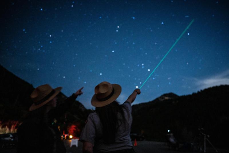 Ranger pointing into the sky with a green laser