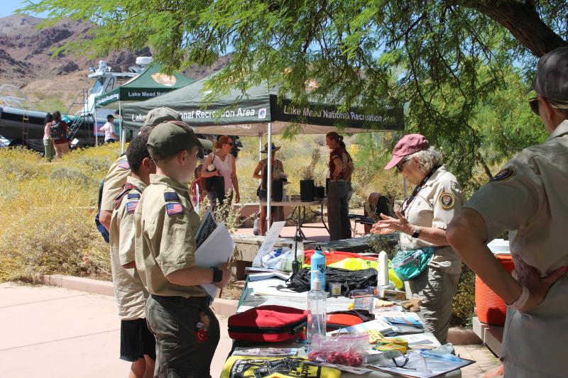 Scouts engaging with LAKE volunteers at an interactive table