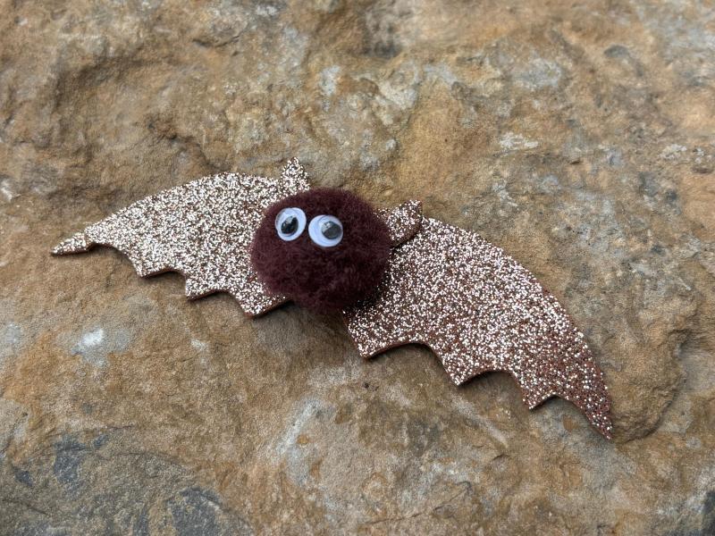 Brown bat made out of a cotton ball and sparkly paper