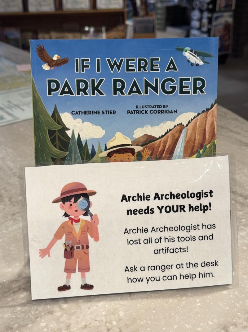 "If I Were A Park Ranger" book behind an advertisement for an Archeology Scavenger Hunt.