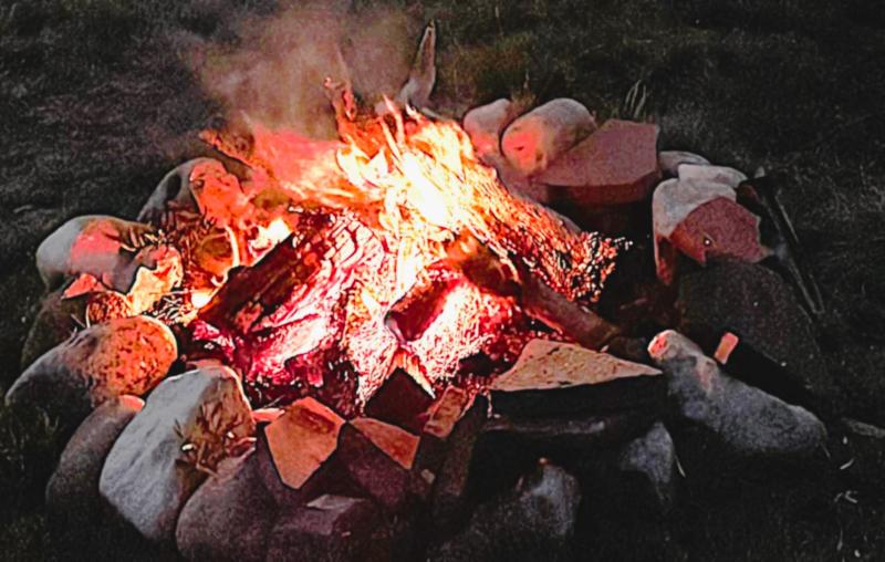 Closeup of a stone-ringed campfire.