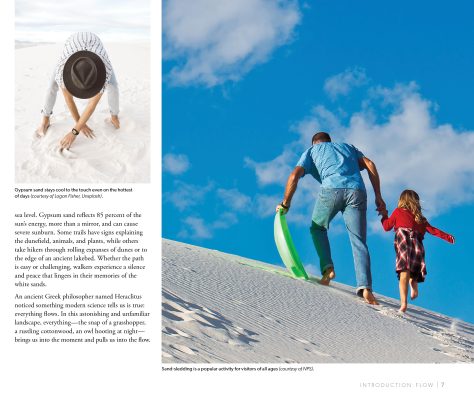 Man and child sledding at White Sands National Parks gypsum dunes